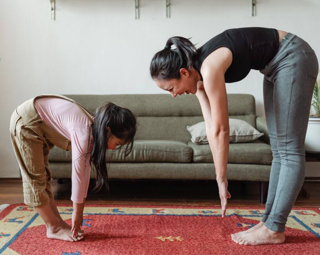 A mother and her child practice self-care journaling together. A mother and her child practice self-care journaling together.