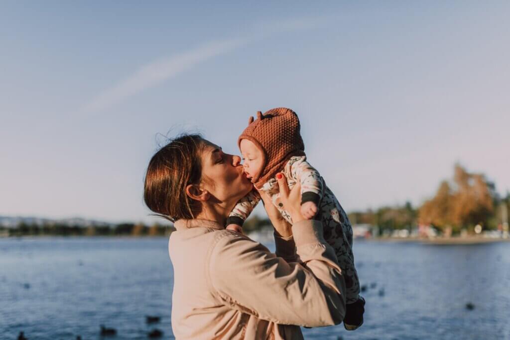 A Mother Giving Her Baby a Kiss