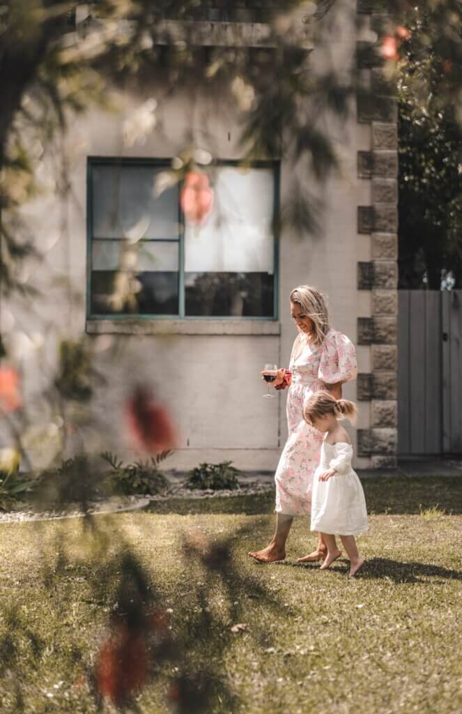 Barefoot mother and daughter on terrace