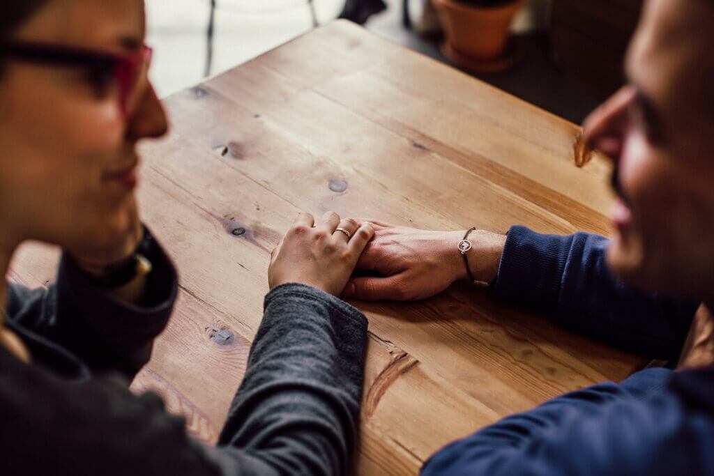 Man and Woman Sitting Together in Front of Table. How to thrive as a stay at home mom? Communicate openly with your partner! Man and Woman Sitting Together in Front of Table. How to thrive as a stay at home mom? Communicate openly with your partner!