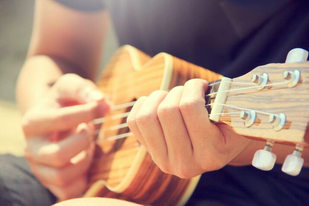 Person Playing Brown Ukulele. How to thrive and not just survive as a stay-at-home mom? Hobbies!