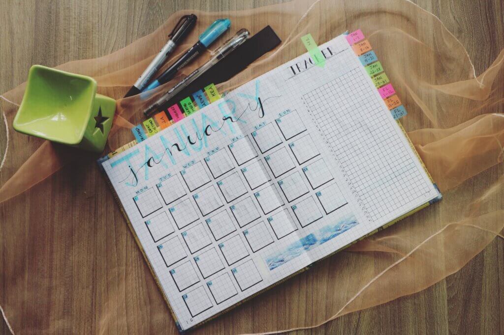20 self care ideas for stay at home moms. Photo of Planner and Writing Materials. Creating a routine is step towards acting on these 20 self care ideas for stay at home moms.