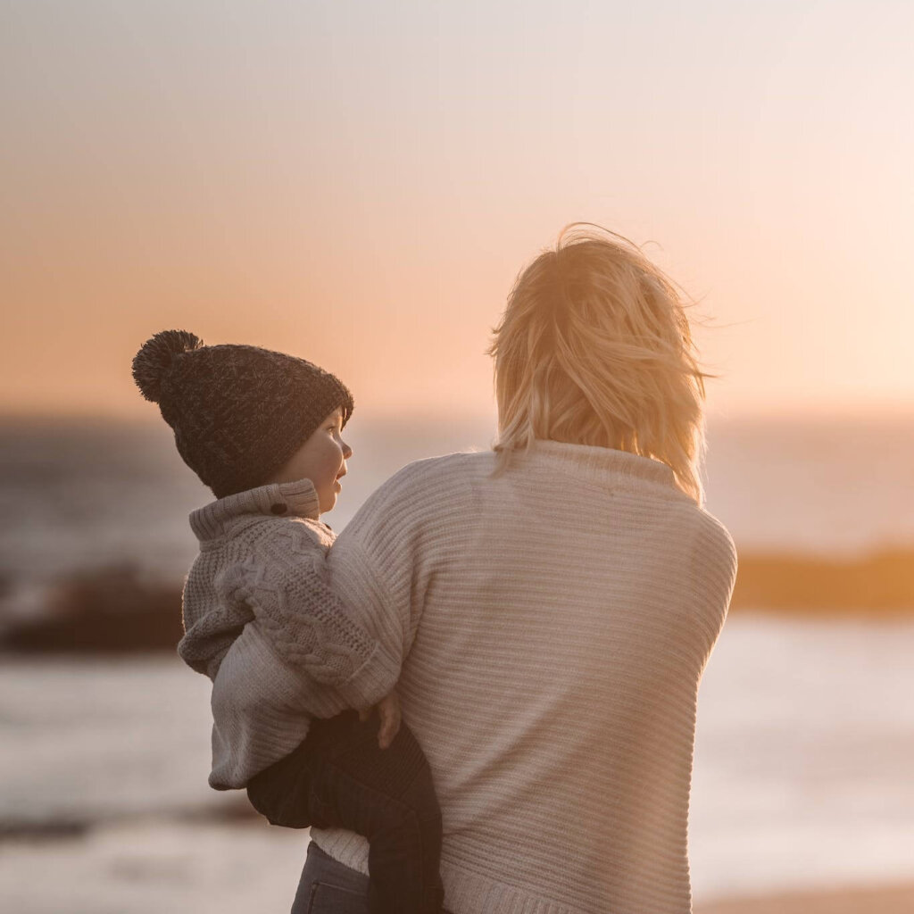 Photo Of Woman Carrying Child