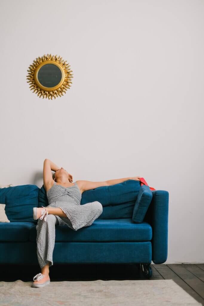 A woman fighting stay-at-home mom burnout on a couch