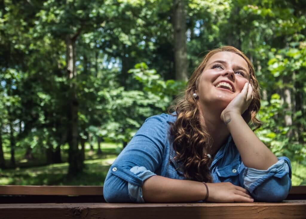 Woman Looking Up Smiling thinking “ What is a stay-at-home mom”